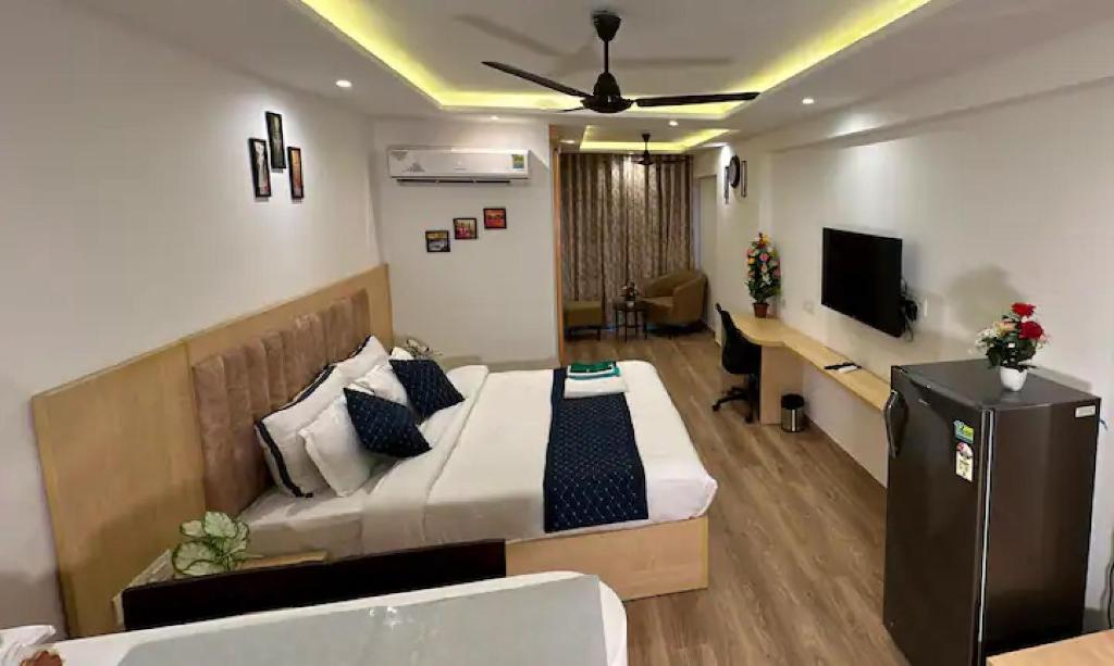 a hotel room with a bed and a television at The Grand Anukampa Oasis in Jaipur lookinghotel