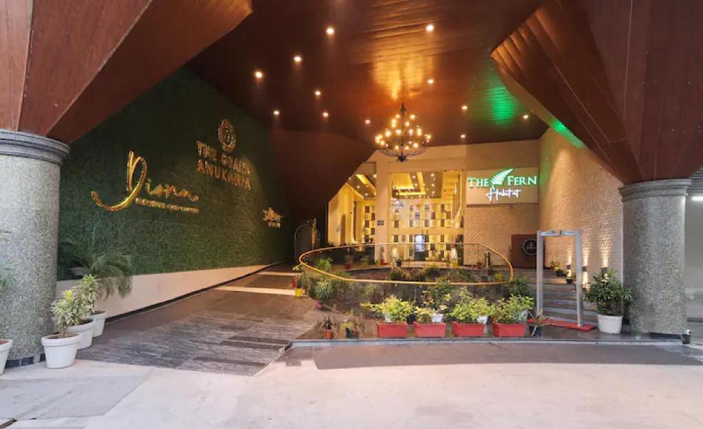 a lobby of a building with plants in pots at The Grand Anukampa Oasis in Jaipur