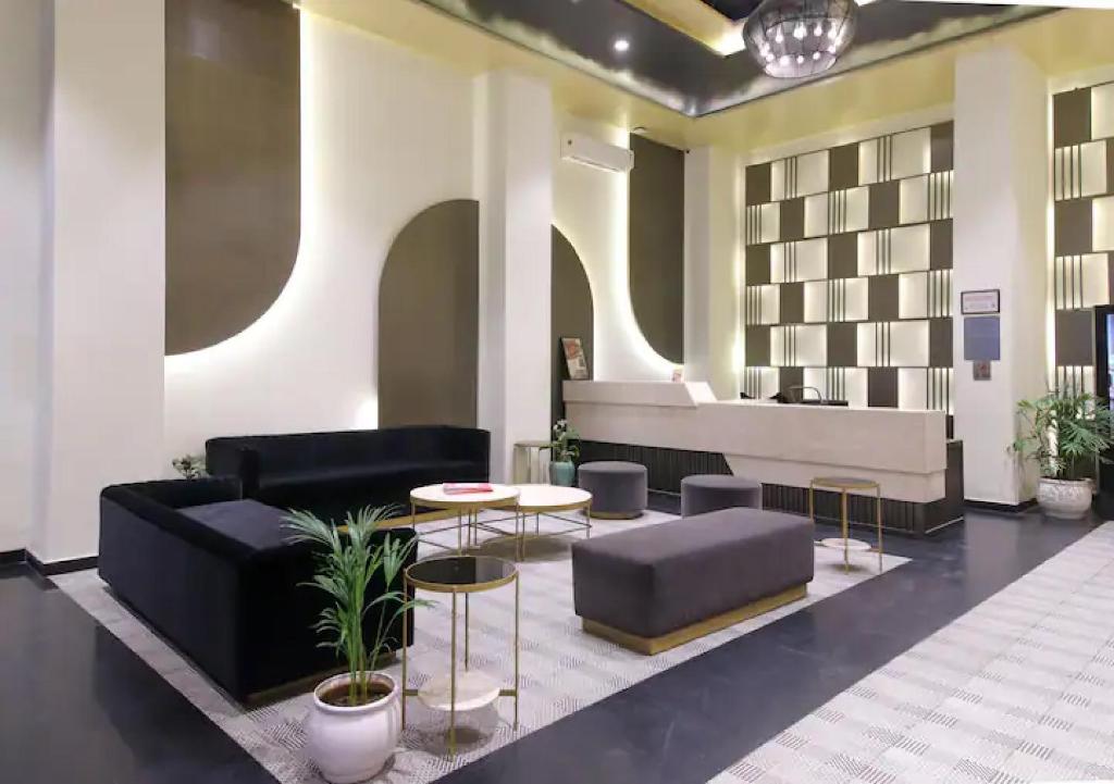 a lobby with a couch and a table and chairs at The Grand Anukampa Oasis in Jaipur