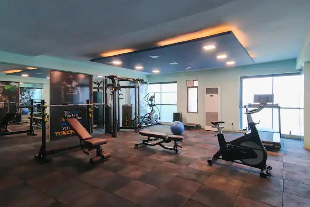 a gym with treadmills and exercise equipment in a room at The Grand Anukampa Oasis in Jaipur