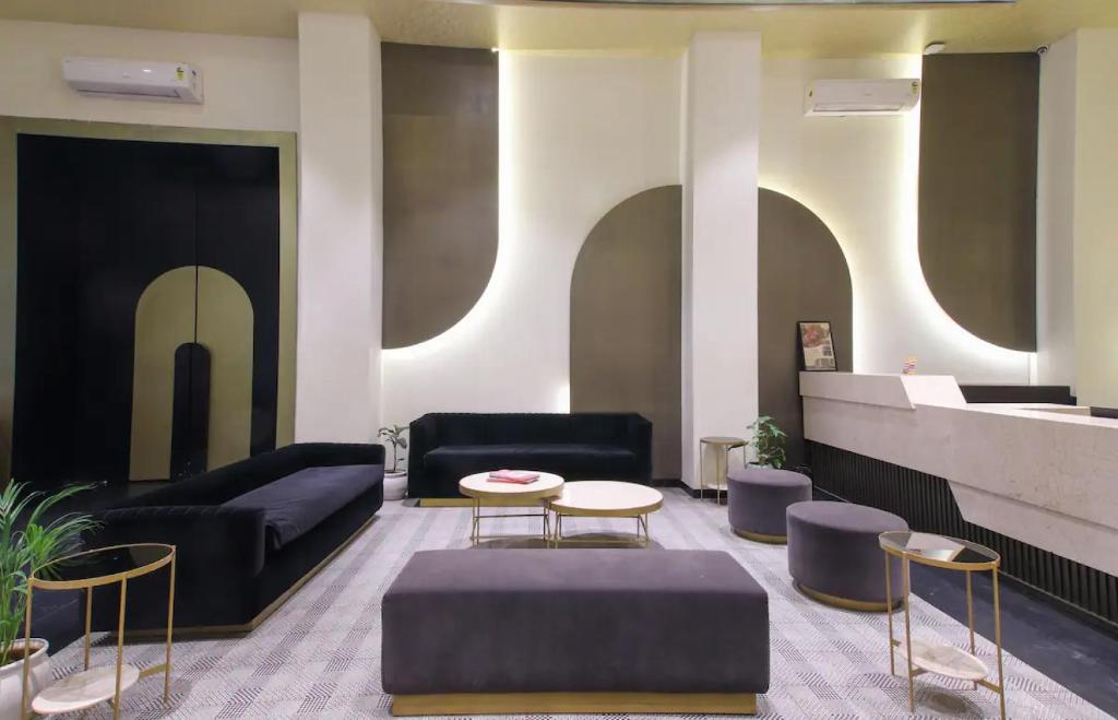 a lobby with a couch and a table and chairs at The Grand Anukampa Oasis in Jaipur