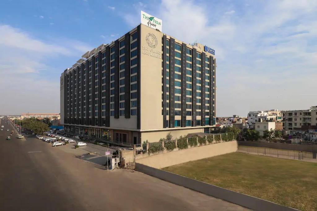 a large building with a sign on top of it at The Grand Anukampa Oasis in Jaipur lookinghotel.com
