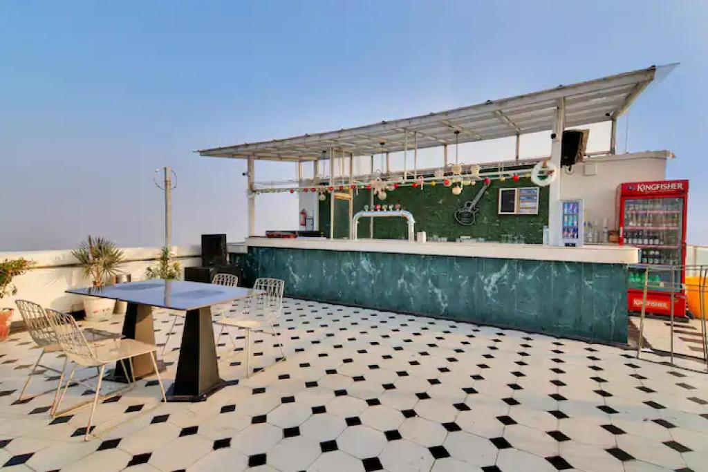 a bar with a table and chairs on a patio at The Grand Anukampa Oasis in Jaipur