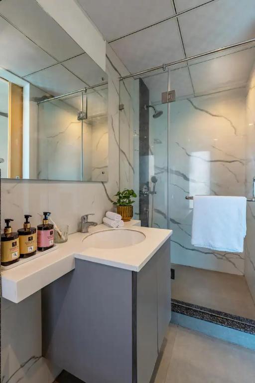 a white bathroom with a toilet and a sink at The Grand Anukampa Oasis in Jaipur lookinghotel.com
